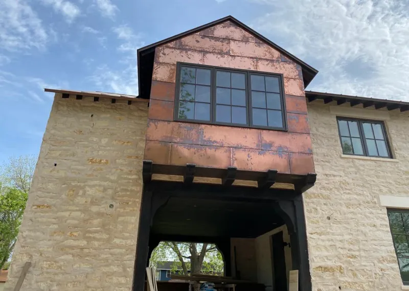 Copper metal panel facade on a stone building for Skylight Installation in Chanceford